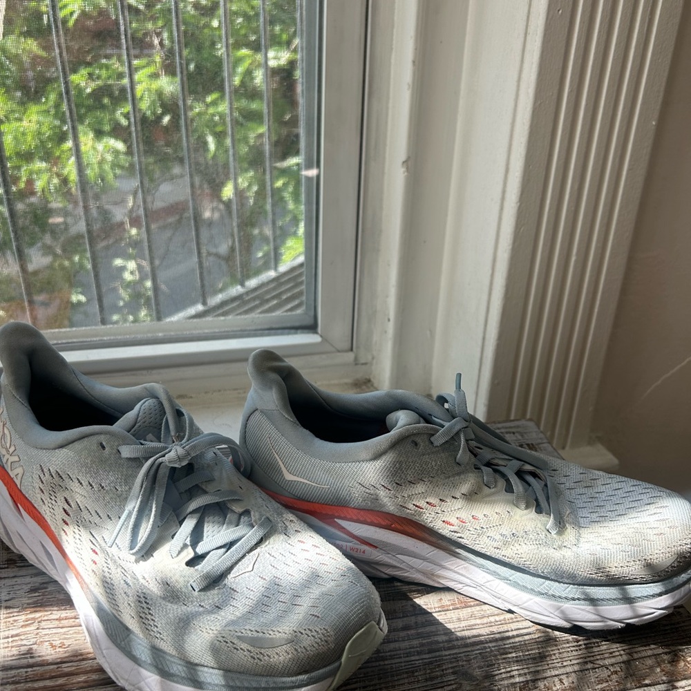 Hoka Light Blue Running Shoes with Orange Highlights